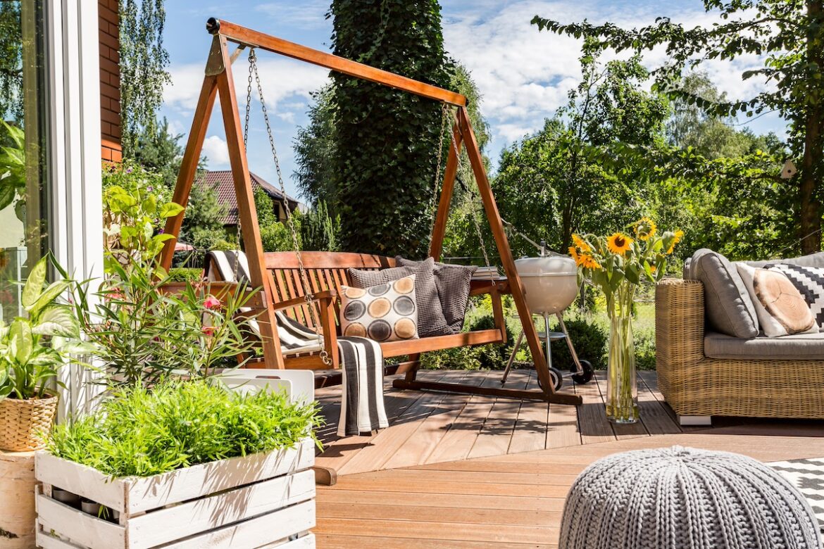 Jardín con sillón balancín y vegetación